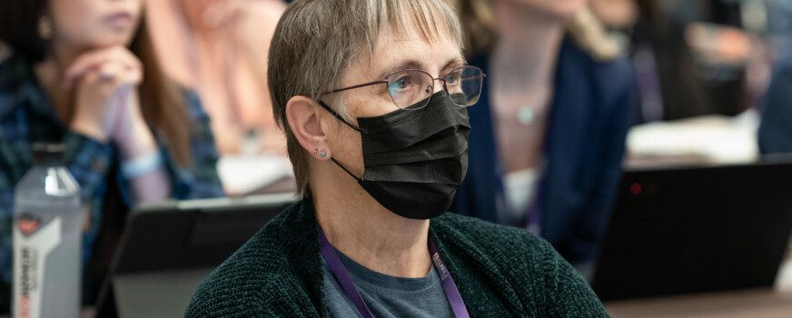 conference audience member wearing mask